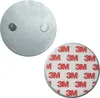 Two circular metal discs, one with adhesive backing and the other with two small protrusions. Produktbild-Vorschau