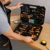 A person is opening a tool case filled with various tools. Produktbild-Vorschau