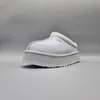 A single UGG Tazz slipper is shown from a side-angle against a plain gray background. Produktbild-Vorschau