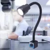 A close-up of a magnetic LED work light illuminating a precision measuring device, with a person blurred in the background. Anteprima dell’immagine prodotto