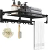 A black metal bathroom shelf with shelves and hooks, holding toiletries, towels, and accessories. Náhľad obrázku produktu