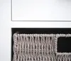 A close-up view of a woven basket inside a white cabinet. Anteprima dell’immagine prodotto