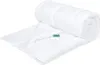 A white duvet is rolled up and partially unrolled on a white background. Voir les images du produit