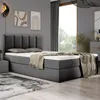 A bedroom scene with a bed, rug, and artwork on the wall. Produktbild-Vorschau