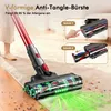 A person is using a red and black cordless vacuum cleaner on a beige carpet. The vacuum head is shown with green light effects indicating suction, and there are small debris particles on the carpet. Inset images show instructions for the brush head. Produktbild-Vorschau