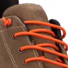 A close-up view of the lacing area of a brown hiking boot. Voir les images du produit