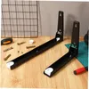 Two black adjustable stainless steel microwave wall brackets are laid out on a wooden surface, along with some screws and a screwdriver. Produktbild-Vorschau