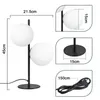 A diagram showing the dimensions of a black table lamp with two white globe-shaped lights. Náhľad obrázku produktu