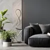 A modern living room with a sofa, plants, and a unique floor lamp. Produktbild-Vorschau