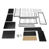 Disassembled parts of a black kitchen storage cabinet laid out on a white background. Voir les images du produit
