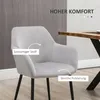 A light gray armchair with black legs is shown in a room setting, next to a wooden dining table. Text overlays highlight features of the chair. Voir les images du produit