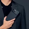 A person in a suit holding a phone case. Náhľad obrázku produktu