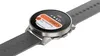 A close-up shot of a smartwatch with a gray band and a silver casing. Produktbild-Vorschau