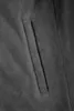 A close-up view of a gray fabric pocket on a garment. Produktbild-Vorschau