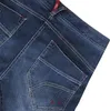 Ravage Jeans von Ocun; dunkelblaue Kletterhose mit zwei Gesäßtaschen und roten Nähten. Anteprima dell’immagine prodotto