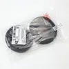 Two black circular ear pads are shown in a clear plastic bag, with labels attached. Produktbild-Vorschau