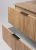 Close-up view of two open drawers of a wooden cabinet with ribbed fronts and black handles. Anteprima dell’immagine prodotto