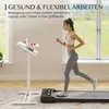 A woman is jogging on a treadmill next to a height-adjustable standing desk with a laptop and fruit on it. Voir les images du produit