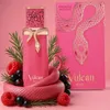 A perfume bottle and its packaging are displayed with decorative elements. Voir les images du produit