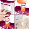 A collage of four images showing the process of using a baby food maker and storing the food. Produktbild-Vorschau