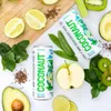 A flat lay of Coconaut coconut water cans surrounded by fresh ingredients like limes, avocados, apples, kiwis, and spinach. Produktbild-Vorschau