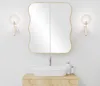 A bathroom vanity with a sink, mirror, and wall sconces. Podgląd zdjęcia produktu
