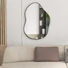 A modern living room with a couch and an abstract mirror on the wall. Produktbild-Vorschau