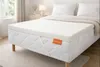 A mattress topper is placed on a mattress on a bed in a bedroom. Náhled obrázku produktu