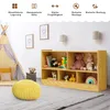 A children's playroom with a wooden toy shelf filled with toys, a teepee tent, and a yellow pouf. Produktbild-Vorschau
