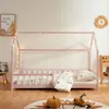 A child's pink house bed with bedding and decorative lights, set in a room with a rug and wall art. Produktbild-Vorschau