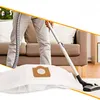 A person is vacuuming a white vacuum cleaner bag in a living room. Voir les images du produit