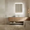 A modern bathroom with a vanity, mirror, and bathtub. Produktbild-Vorschau