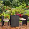 A garden furniture set with a table and two chairs placed on a wooden deck in a lush garden setting. Anteprima dell’immagine prodotto