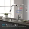 A kitchen faucet shown in a modern kitchen setting, demonstrating its 360-degree rotation. Podgląd zdjęcia produktu