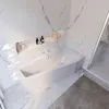 A modern, minimalist bathroom with a white bathtub and marble-effect walls. Produktbild-Vorschau