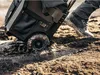 A person is pulling a large, black rolling tool case through mud and puddles. Náhled obrázku produktu