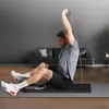 A man is doing a workout at home with a resistance band. Produktbild-Vorschau