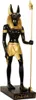 A statue of the Egyptian god Anubis standing on a base. Anteprima dell’immagine prodotto