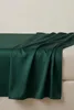 A dark green satin-cotton fitted sheet draped over a bed. Produktbild-Vorschau