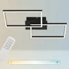 A modern black LED ceiling light with two interlocking rectangular frames, shown mounted on a light gray wall. A white remote control is in the foreground, and a color temperature slider graphic is at the bottom. Produktbild-Vorschau