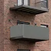 Two balconies on a brick building, one above the other. The lower balcony has a grey privacy screen. Produktbild-Vorschau