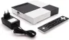 A set of electronic devices including a set-top box, a remote control, and a power adapter, arranged on a white background. Produktbild-Vorschau