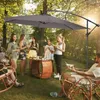 People enjoying a picnic under a large cantilever umbrella in a garden setting. Náhled obrázku produktu
