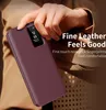 A hand holding a burgundy leather flip case for a smartphone, with the phone's screen visible. Produktbild-Vorschau