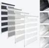 A display of multiple roller blinds in different colors and sizes, arranged diagonally.