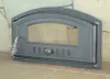 A cast iron oven door with a glass window, set against a stone wall and a stone hearth. Produktbild-Vorschau