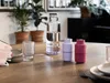 A table setting with a water bottle, a glass, and two spice grinders. Produktbild-Vorschau