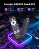 A black TV stick and remote control are placed on a stylized circuit board with glowing purple and blue lights. Náhled obrázku produktu