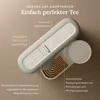 A top-down view of a modern tea machine with descriptive text highlighting its features. Produktbild-Vorschau