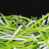 Shredded paper strips in green and white. Anteprima dell’immagine prodotto